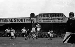 The Rangers goalkeeper clutches the ball watched by Billy Arnison