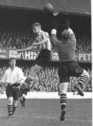 Wally Shanks watches Bernard Streten gather the ball