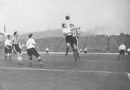 Bob Morton wins this heading duel with Owls striker Derek Dooley