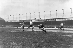 Bernard Streten gathers the ball as future Hatter Allan Brown gives chase
