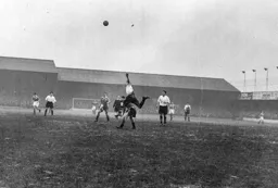 Syd Owen heads the ball high into the sky