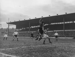 Johnny Downie and Roy Davies look on as Gordon Bradley safely catches the ball