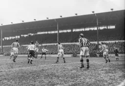 The County defence clear the ball as Joe Scott and Roy Davies look on