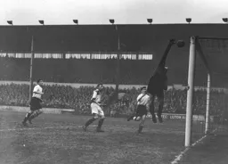 Jim Pemberton and Jim Adam watch as Howard Radford tips the ball over the bar