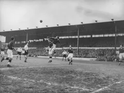 Gordon Turner looks on as Terry Webster punches the ball clear