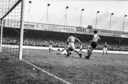 Jimmy Adam watches as the Forest defence scramble the ball clear