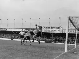Mitch Downie takes the ball away from Jimmy Adam`s head as Peter MacEwan looks on