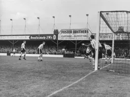 Roy Davies heads the ball across the face of the goal