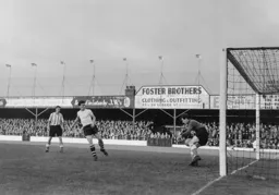 Jimmy Adam watches Mitch Downie appears to save the ball between his knees