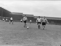 George Cummins nips in between defenders to win the ball