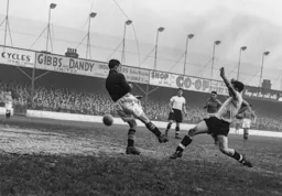 Bob Morton puts the ball past Ken Hardwick but it does not add to the score