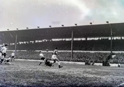 The keeper goes down bravely at the feet of Bob Morton