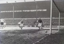 John Groves watches Gordon Turner`s shot head towards the net for Town`s second goal