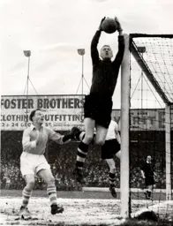 Ron Baynham shows a safe pair of hands under pressure from City`s Joe Hayes