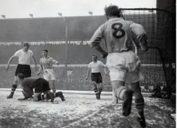Town repell a City attack as Ron Baynham falls on the ball