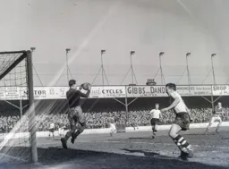 Ian Black safely catches the ball as Mick Cullen looks on