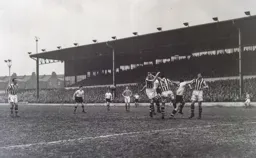 Tommy Deans and Harry Adamson clear the ball away from Bob Morton