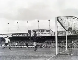John Groves charges in as George Taylor has the ball under control