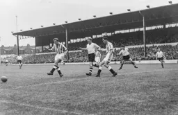 Peter MacEwan looks on as Tony Marchi clears the ball