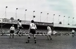 Joe Kennedy heads the ball away under pressure from Gordon Turner