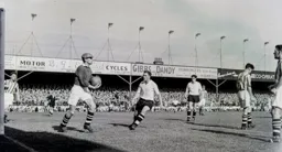 Jim Sanders has hold of the ball and Peter MacEwan is frustrated once again