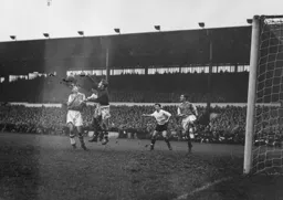 Con Sullivan punches the ball clear from Gordon Turner