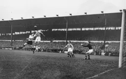 Peter MacEwan loses out in this heading duel