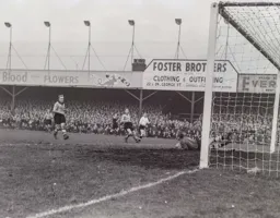 Bert Williams gets down to save this effort by Bob Morton