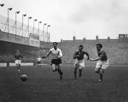 Bob Morton leads in a race for the ball