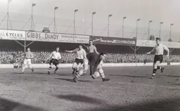 Ken Grieves scoops up the ball. Roy Davies Gordon Turner and Tony Gregory are out of luck once more