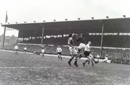 Tony Gregory makes his presence felt as Bill Robertson comes out to claim the ball