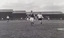 Jimmy Adamson shields the ball as Bob Morton closes in