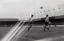 Bob Morton heads the ball over Ray Daniel