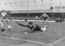 Willie Fraser flounders on the ground as Gordon Turner waits to pounce