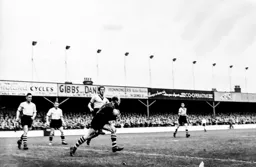 Bernard Streten has the ball in his hands while Wally Shanks provides cover