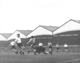 Bernard Streten dives onto the ball