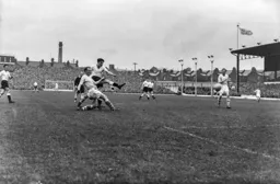 Gordon Turner brushes off Dave Ewings`s challenge to score Town`s third goal