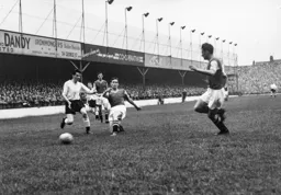 George Cummins is tackled by Peter Aldis