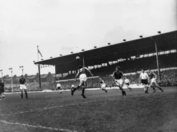Peter Aldis heads the ball clear for Villa watched by George Cummins