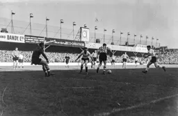 Tony Gregory and Gordon Turner move in to catch Ron Staniforth in posession