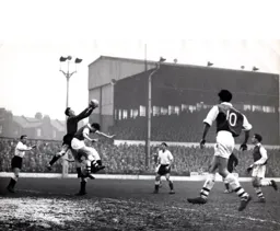 Ron Baynham catches the ball under pressure from David Herd