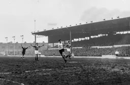 The referee waves play on but Reg Pearce cannot take advantage