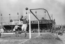 Eddie Hopkinson watches the ball drift wide of the goal with Allan Brown lurking in the background