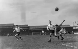 Tommy Banks heads the ball to safety away from Roy Davies