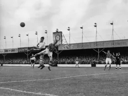 Allan Brown comes under pressure from Eric Bell as he goes up for a header
