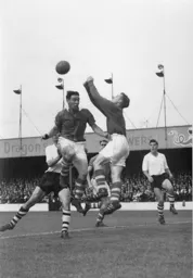 Allan Brown watches as Bolton keeper Eddie Hopkinson puches the ball away