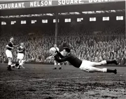 Ron Baynham dives full length to catch the ball
