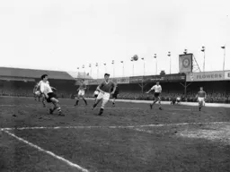 Jimmy Adam sends a high ball towards the United goal