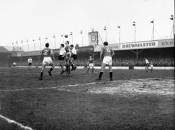 United`s Mark Jones heads the ball away under pressure from John Groves and Allan Brown