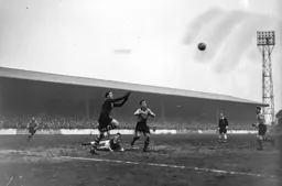 Allan Brown can only watch from the ground as Ken Grieves comes out to catch the ball